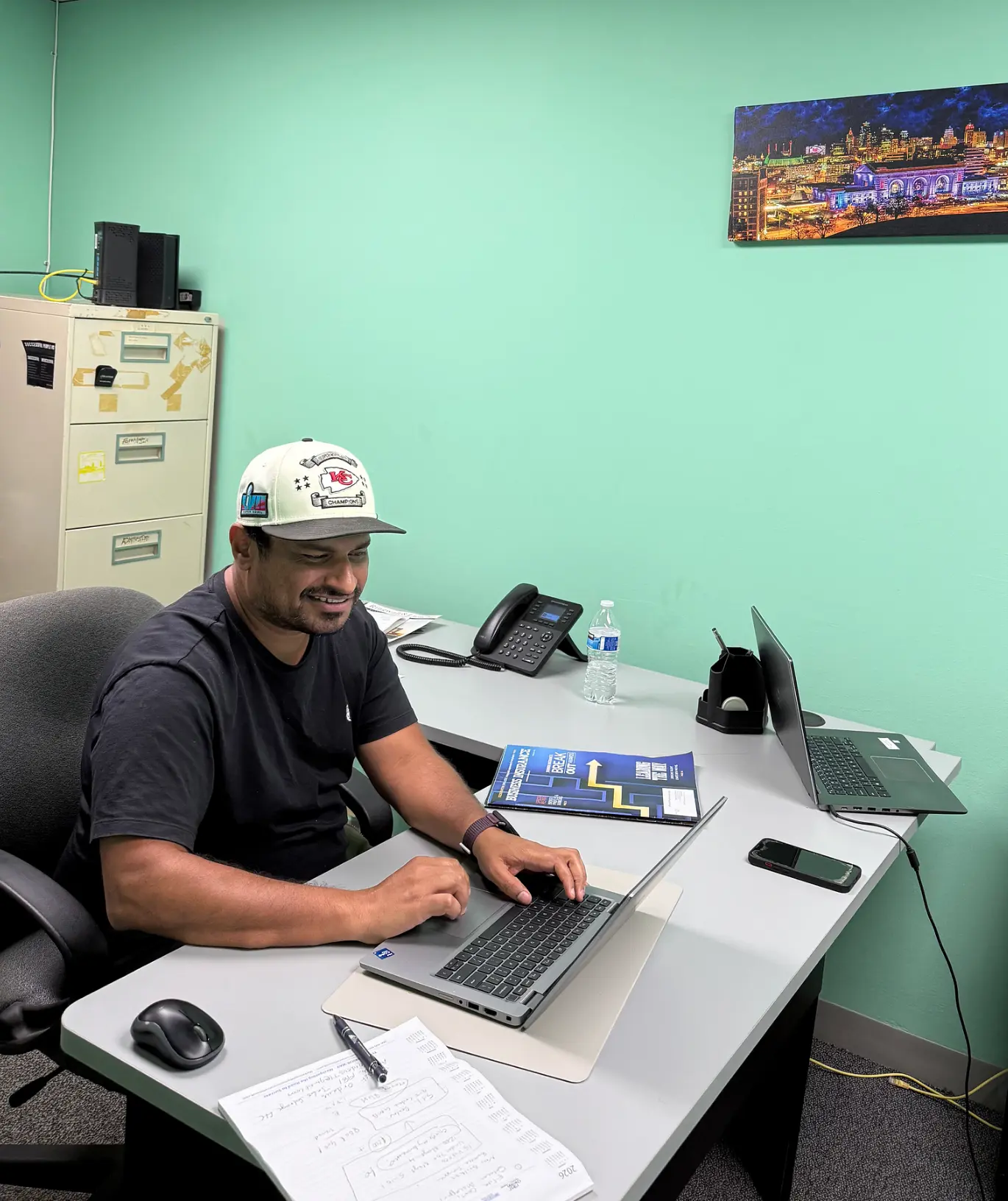Rajan working at his desk at the Nominal Insurance office